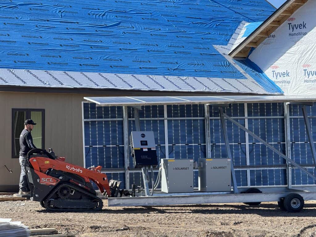 SolarSet solar power system with battery enclosures being set in place at a construction site