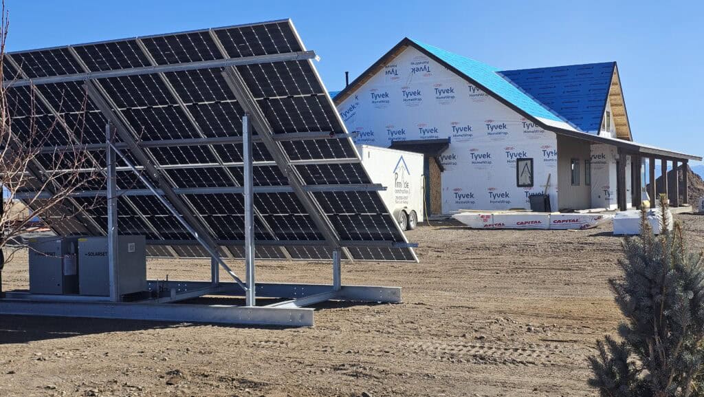 Whole home solar system on a ground mount beside a new house